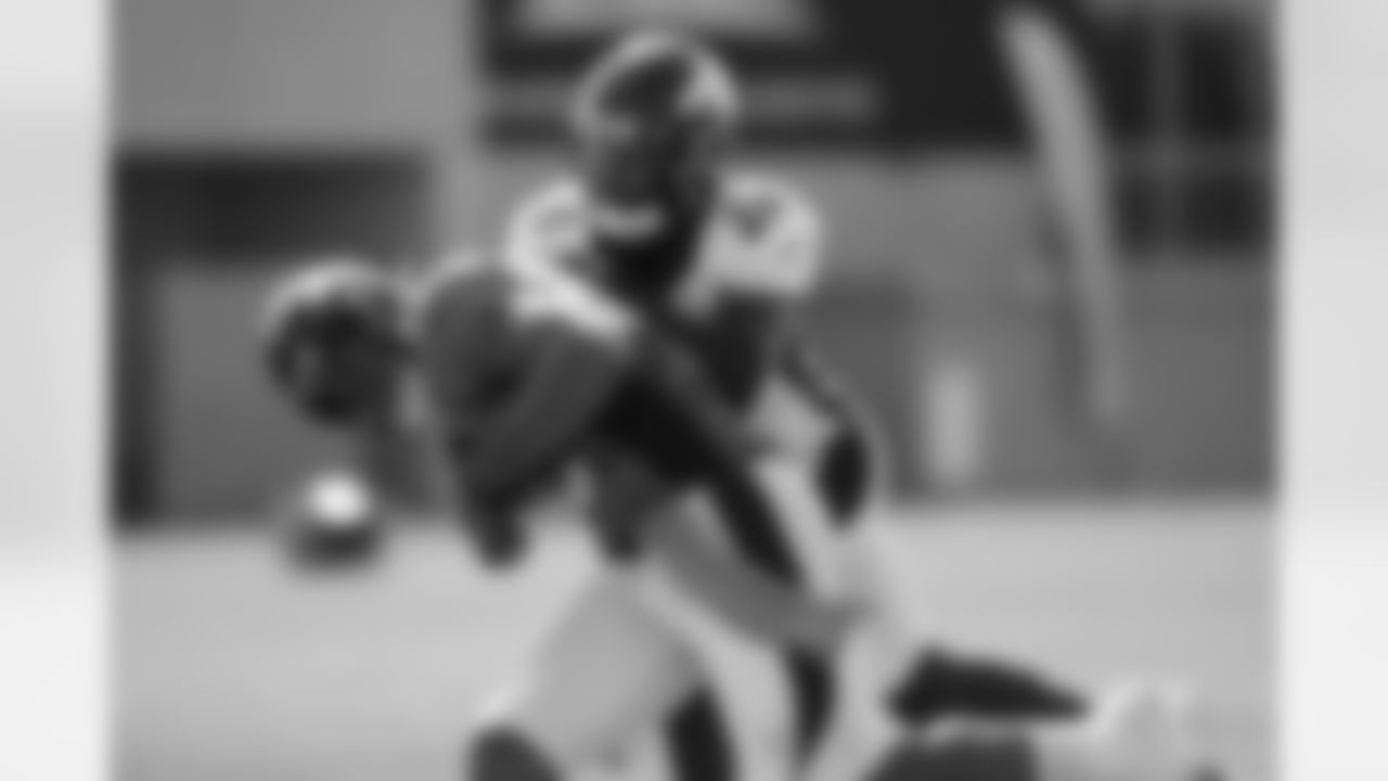 Isaac Yiadom provides a hit as Albert Okwuegbunam carries the ball during the 14th day of training camp at UCHealth Training Center on September 1, 2020. (Photo by Ben Swanson)