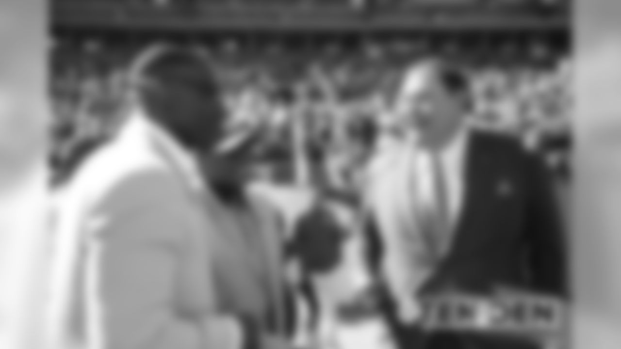 Shannon Sharpe and Floyd Little talk with Pro Football Hall of Fame President and CEO David Baker before the Broncos' game against the Tennessee Titans at Empower Field at Mile High on October 13, 2019. (Photo by Ben Swanson)