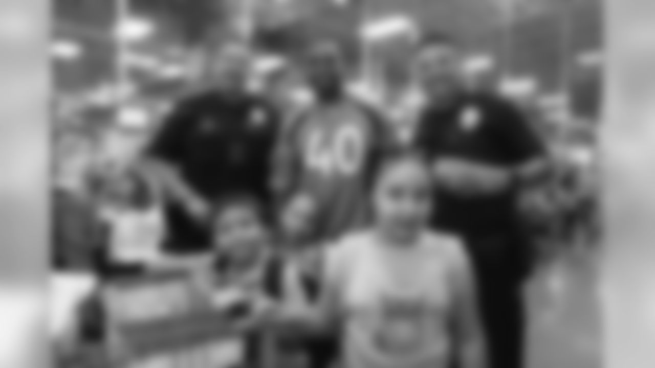 Inside linebacker Keishawn Bierria (40), two police officers and the children that Bierria took shopping at the 2018 Back to School with the Broncos shopping spree on July 23, 2018. Each student received $100 for school supplies.