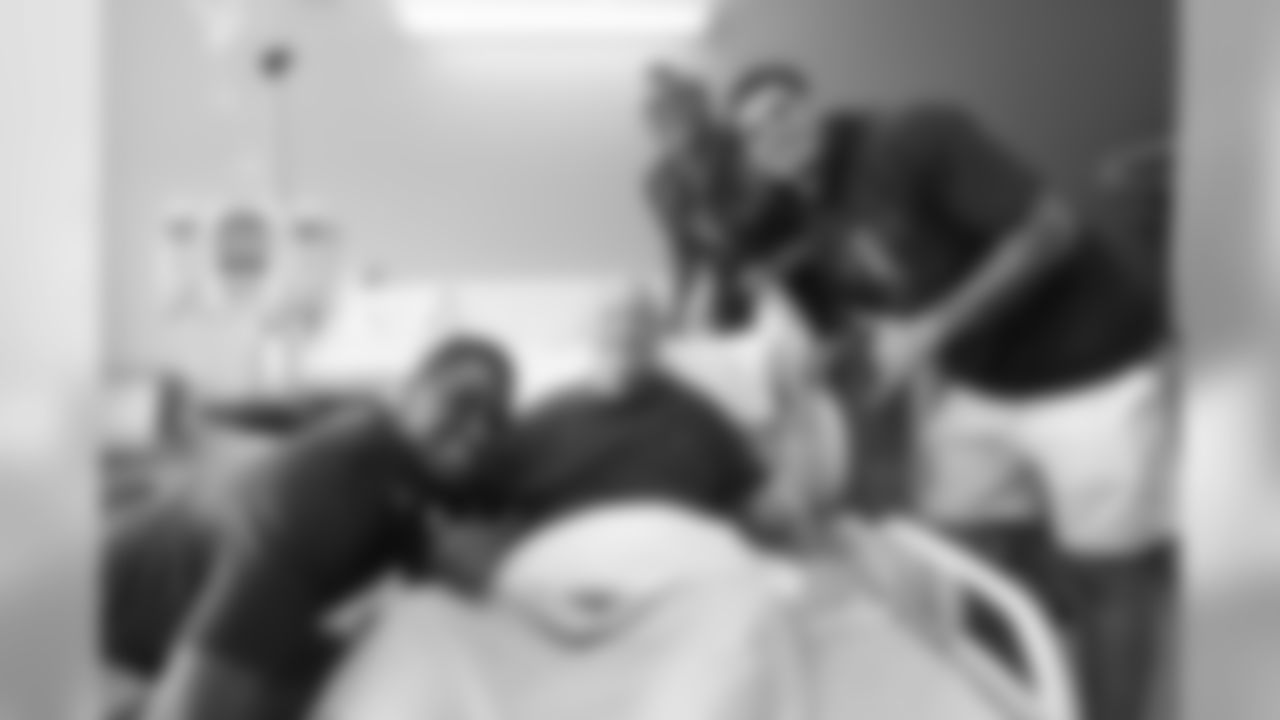 Corey Nelson, Noah Fant and Justin Simmons pose for a photo with a patient during a visit to UCHealth University of Colorado Hospital on September 30, 2019. (Photo by Ben Swanson)