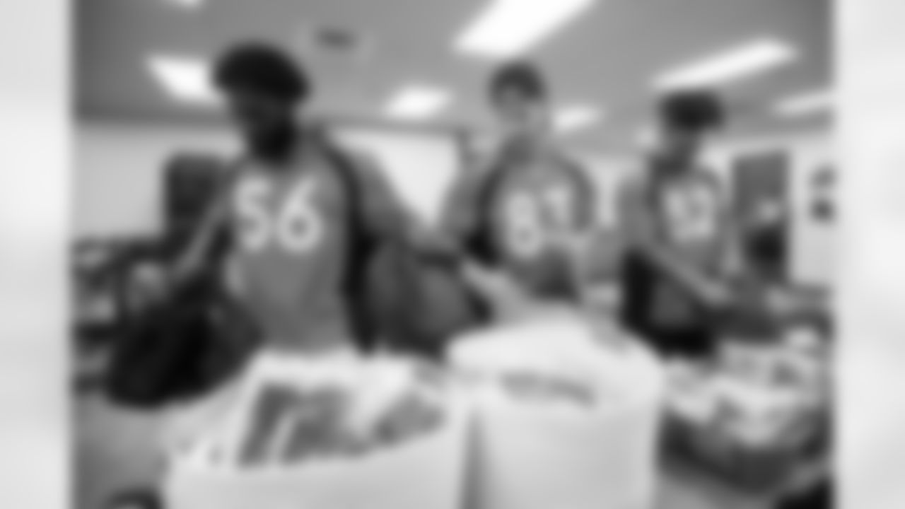 Baron Browning, Andrew Beck and Netane Muti during a community event packaging school supplies provided by King Soopers in 300 backpacks for students on August 31, 2021. (Photo by Ben Swanson)