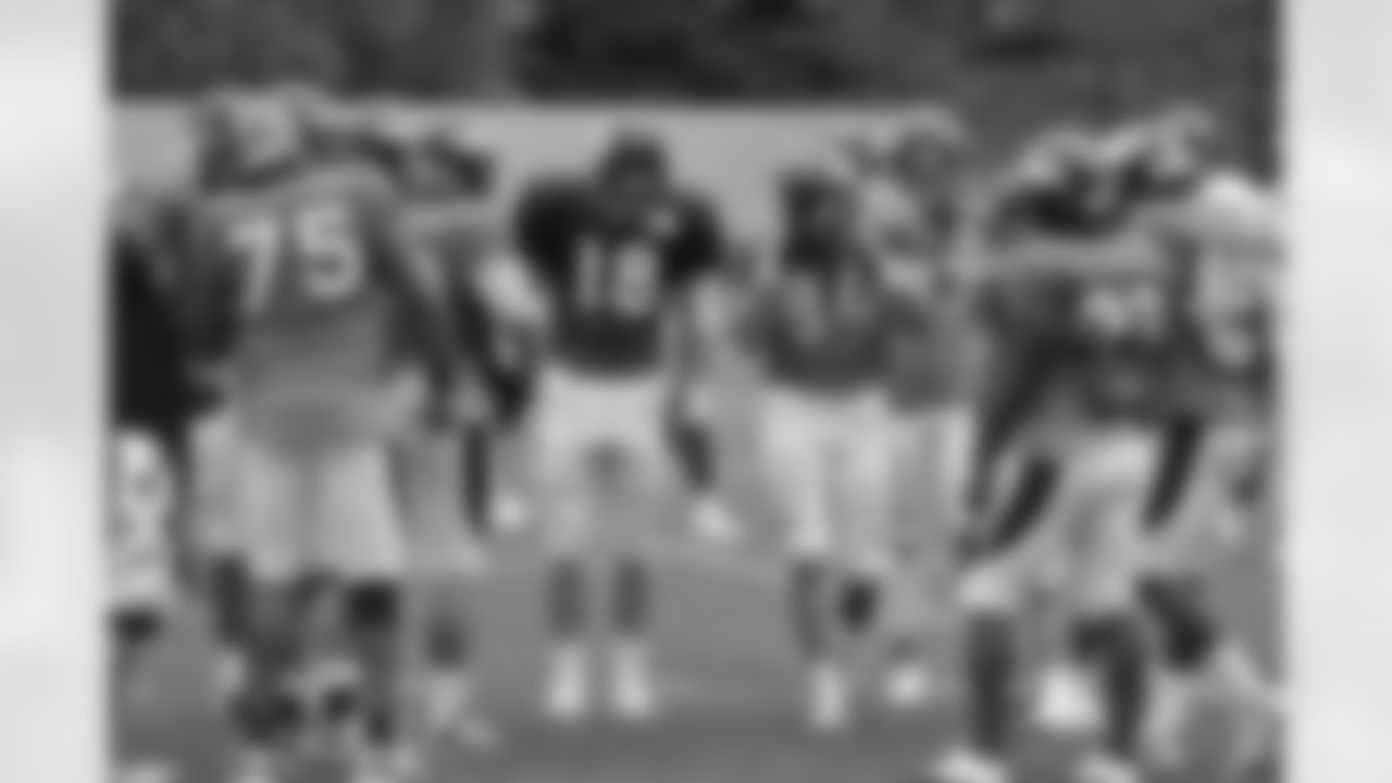 Manning huddles with the offense.