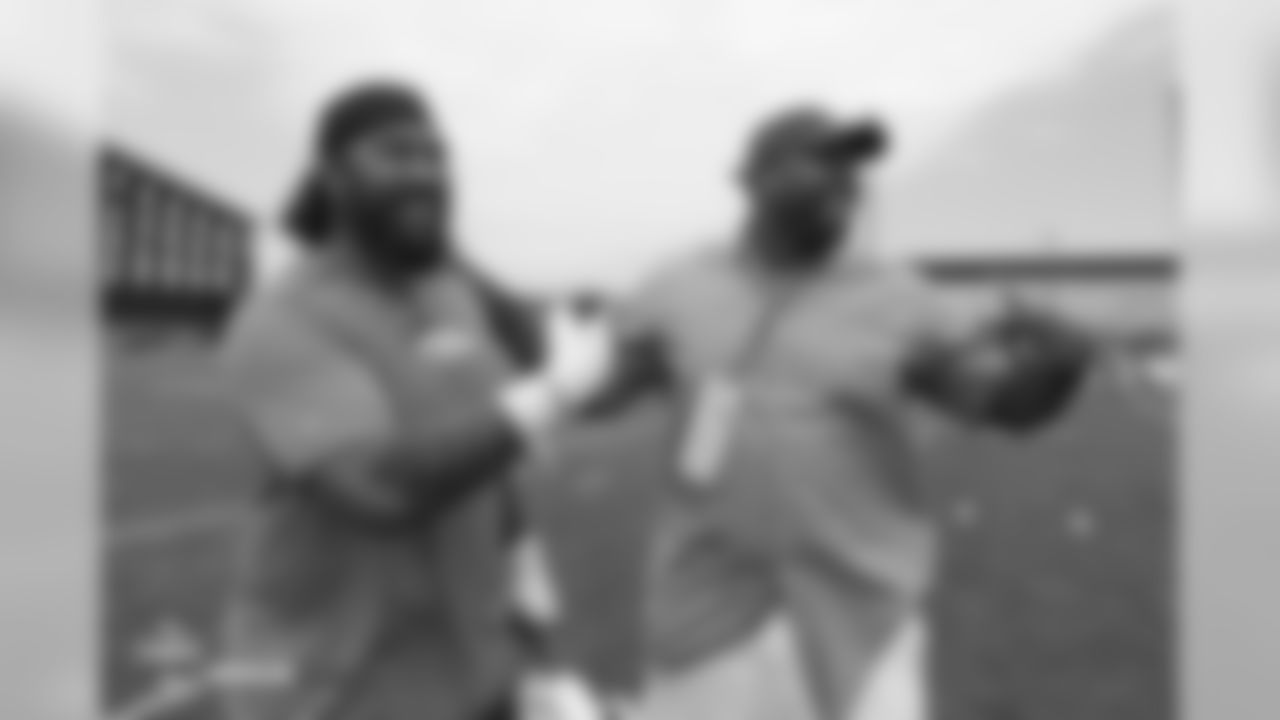 Nose tackle Domata Peko Sr. (94) points to former Bronco Kevin Vickerson as he does the same to him during the 10th day of training camp on August 8, 2018, at UCHealth Training Center. The two were college teammates.