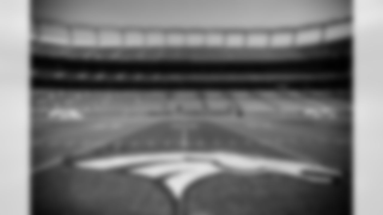 Members of the stadium's turf crew paint the field at Empower Field at Mile High on September 23, 2021 ahead of the team's Week 3 home opener. (Photo by Ben Swanson)