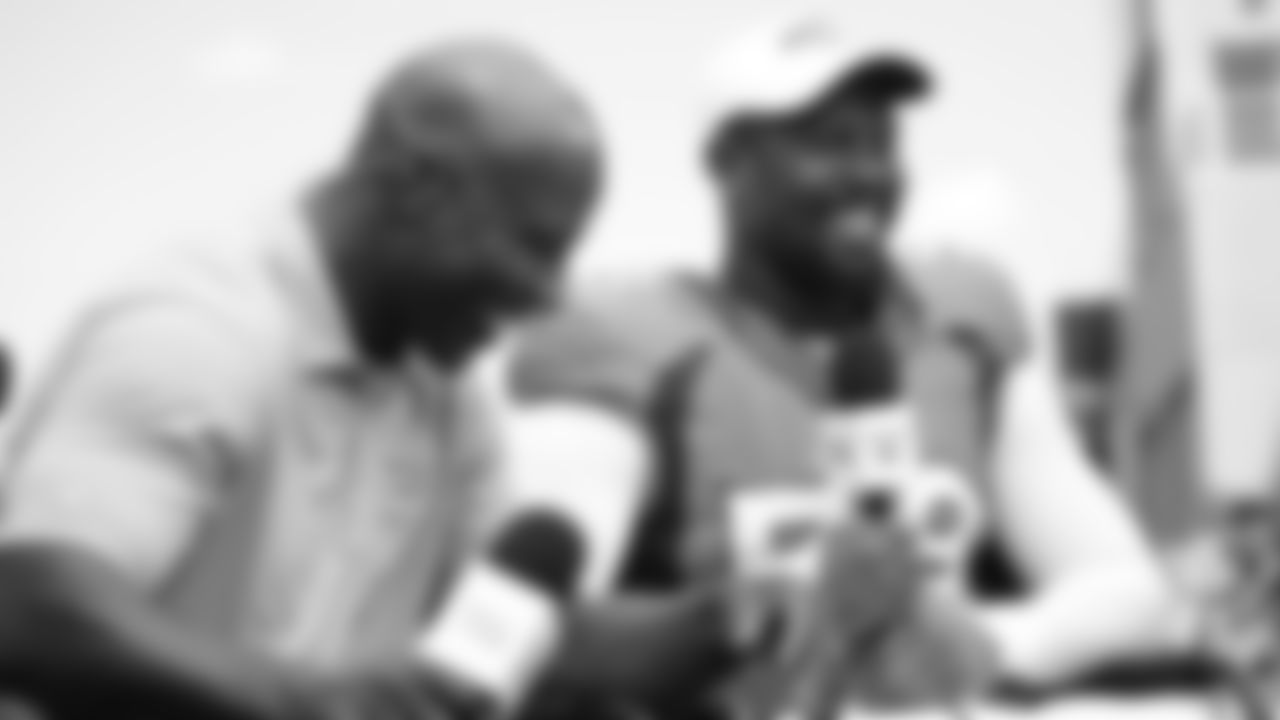 Von Miller talks with Hall of Fame running back and NFL Network host Terrell Davis at practice on Day 5 of training camp on July 22, 2019. (Photo by Ben Swanson)
