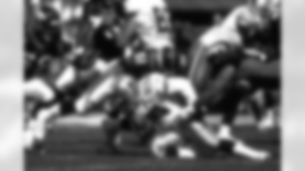 John Mobley puts a hit on Sherman Williams against the Dallas Cowboys at Mile High Stadium in Denver, CO on September 13, 1998.