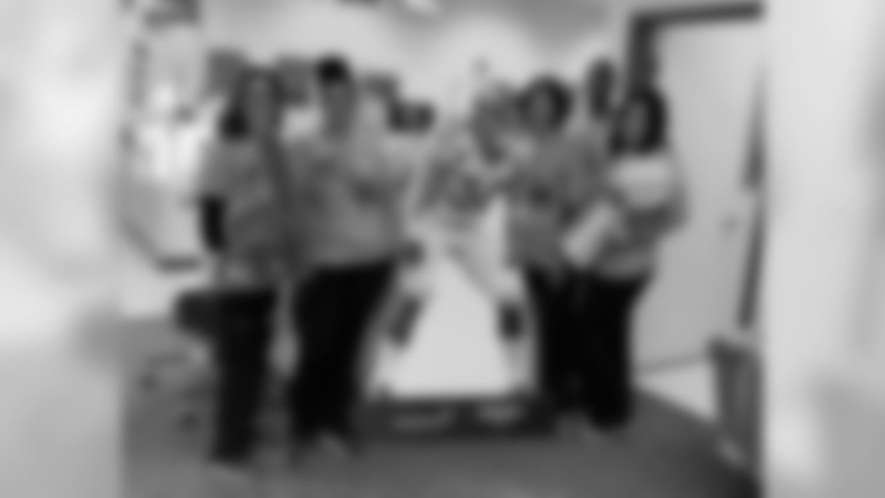 Volunteers pose with a cardboard cutout of Phillip Lindsay at Vitalant's Drive for Life 22 blood drive in Boulder, Colorado on November 5, 2019.