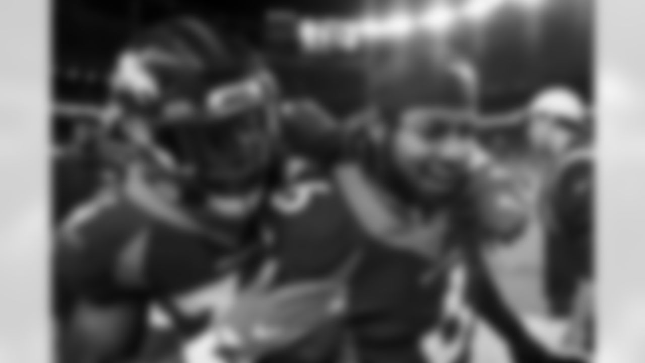 Aaron Patrick congratulates P.J. Locke after his game-clinching forced fumble on the sideline during the Broncos' Week 3 game against the San Francisco 49ers at Empower Field at Mile High in Denver, Colorado on September 25, 2022. (Photo by Ben Swanson)