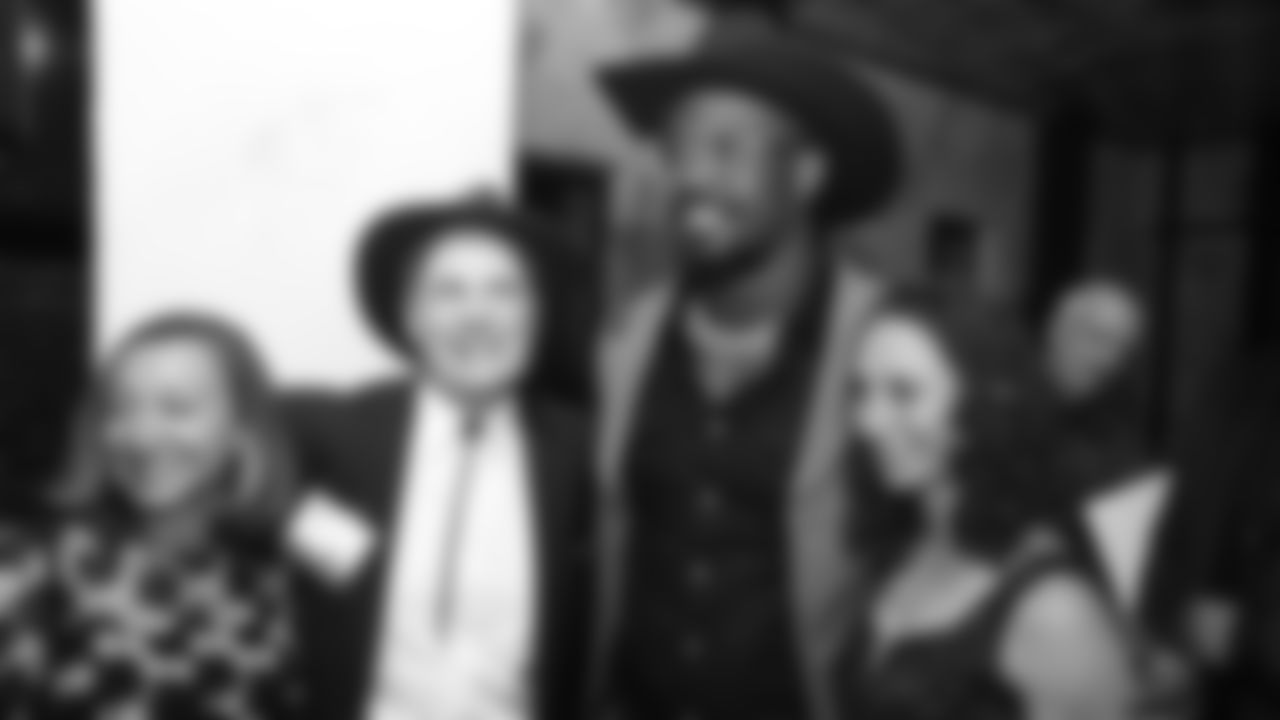 Von Miller poses with guests during Von's Vision at Mile High Station in Denver on November 5, 2018.