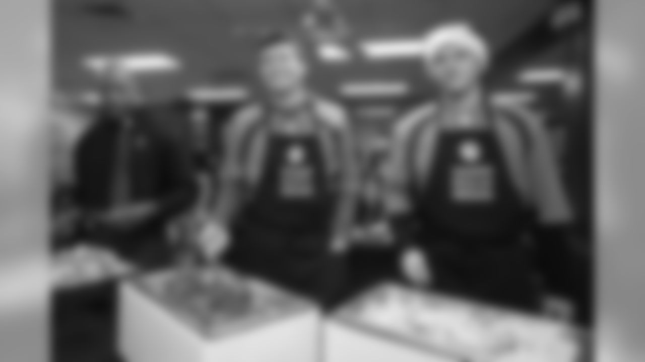 Drew Lock and Brett Rypien and teammates serve dinner at the Denver Rescue Mission's 20th annual holiday party at the Mission's The Crossing location on December 9, 2019. (Photo by Ben Swanson)