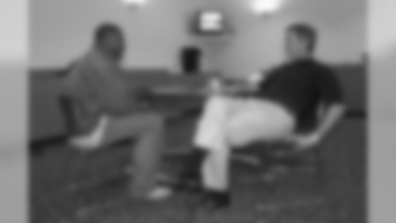 Clinton Portis sits down to talk with head coach Mike Shanahan during Portis' first visit to the Broncos' team headquarters after being selected in the 2002 NFL Draft.