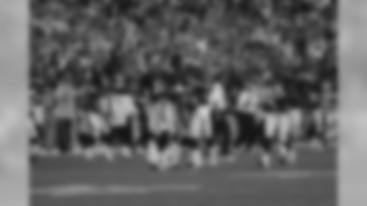Jason Elam is surrounded by his teammates after kicking a 47 yard game winning field goal against the Pittsburgh Steelers at Invesco Field at Mile High in Denver, CO on October 12, 2003.