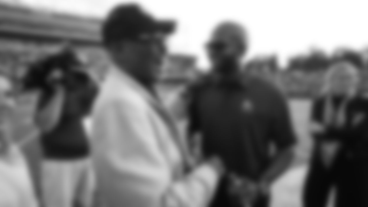 Floyd Little greets Champ Bailey before the Broncos' preseason matchup with the Falcons in the Pro Football Hall of Fame Game on August 1, 2019 at Tom Benson Hall of Fame Stadium.
