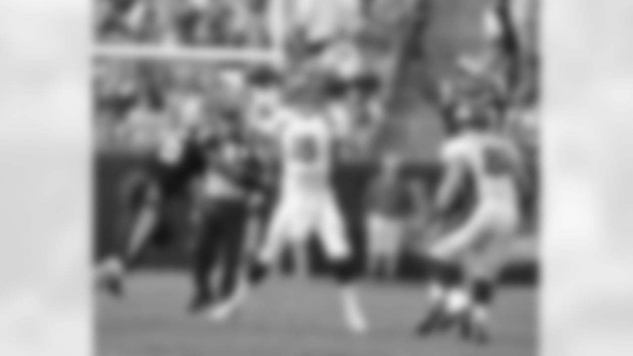Manning looks to throw it over a leaping Panthers defender.