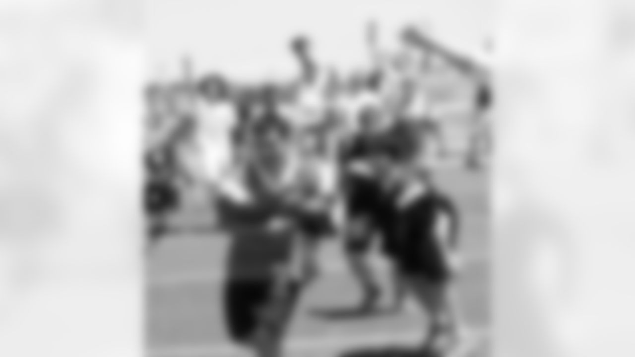 A camper turns and runs after a catch.