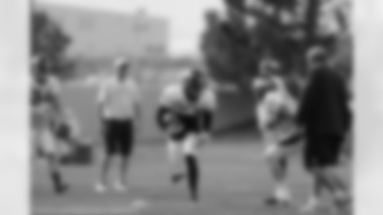 The Broncos safeties work through a tackling drill.