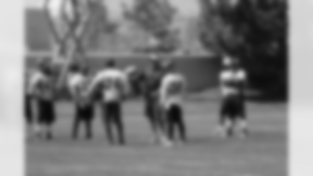 Defensive Coordinator Jack Del Rio talks to a group of defensive backs.