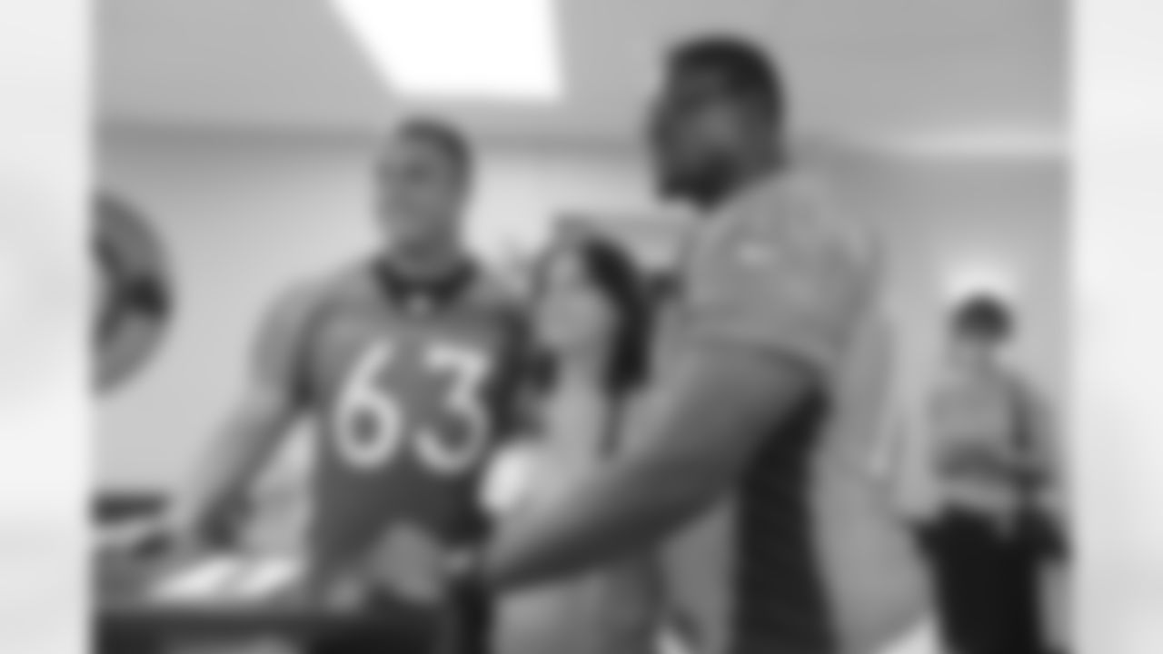 Ben Garland and Ryan Clady pose for a photo with a hospital staff member.