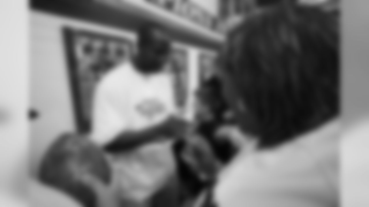 Champ Bailey signs autographs at the ceremony for the grand opening of the Darrent Williams Memorial Teen Center at the Denver Broncos Boys & Girls Club in 2007.