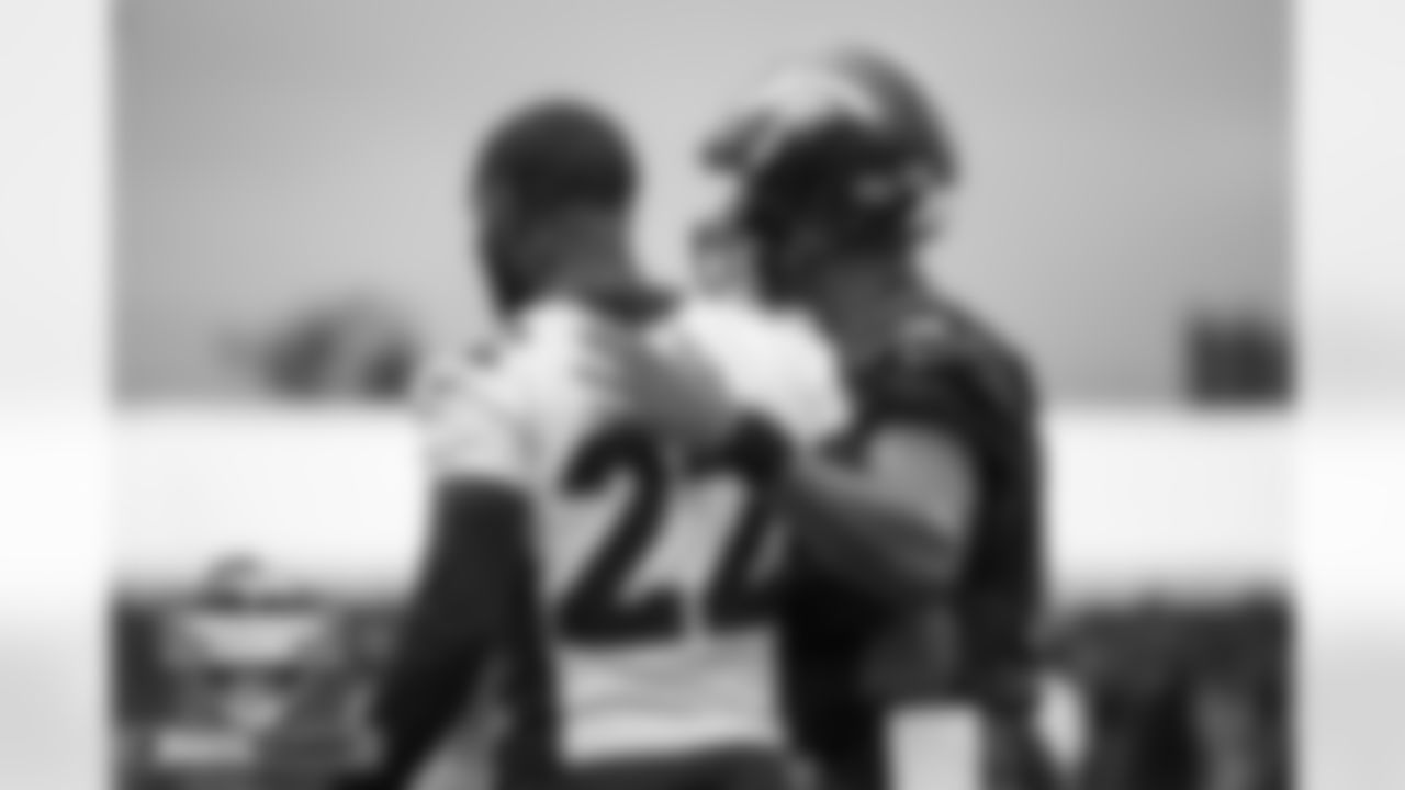 Russell Wilson talks with Kareem Jackson at practice on Day 2 of training camp at UCHealth Training Center in Englewood, Colorado on July 28, 2022. (Photo by Ben Swanson)