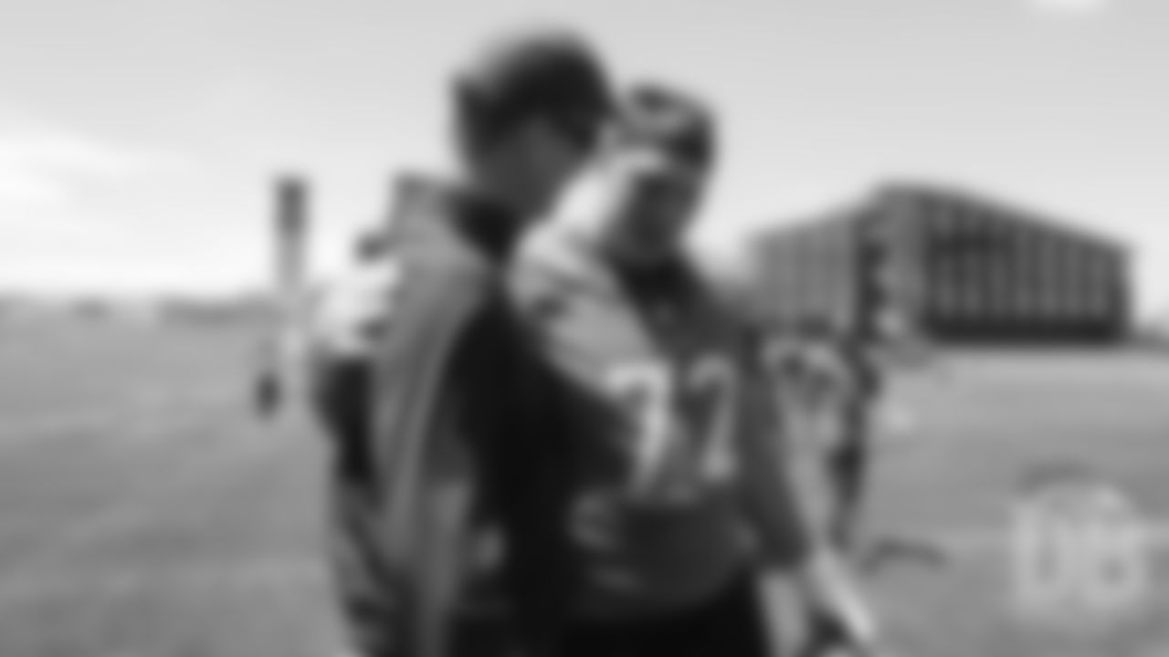 Garett Bolles greets former Broncos quarterback Peyton Manning after the Broncos' practice on the eight day of their OTAs on May 30, 2019.