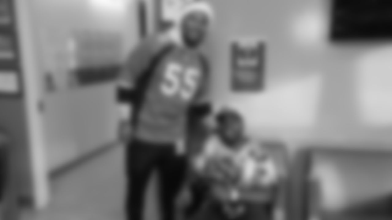 Bradley Chubb poses with a patient during a Build-A-Bear distribution at Children's Hospital Colorado in Aurora on December 17, 2018.
