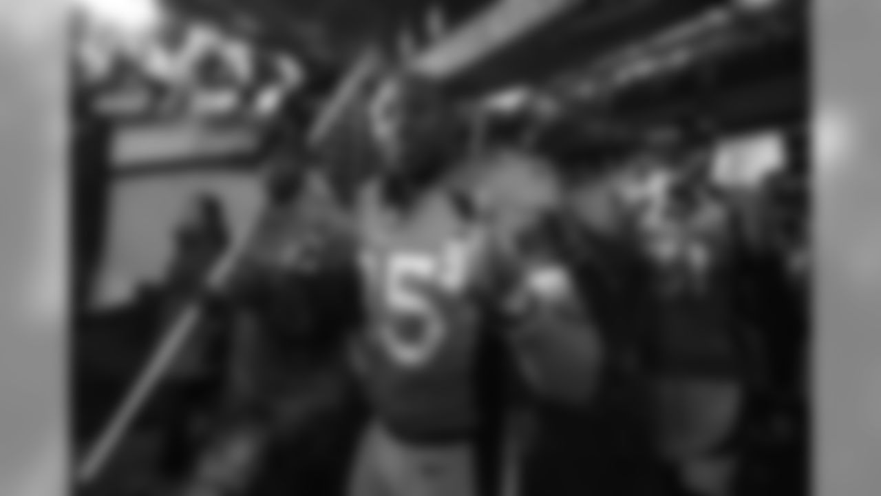 Cornerback Chris Harris Jr. (25) gives thumbs up next to a military member for Salute to Service in the tunnel during player introductions before the Broncos' Week 10 game against the new England Patriots on November 12, 2017. (Ben Swanson)
