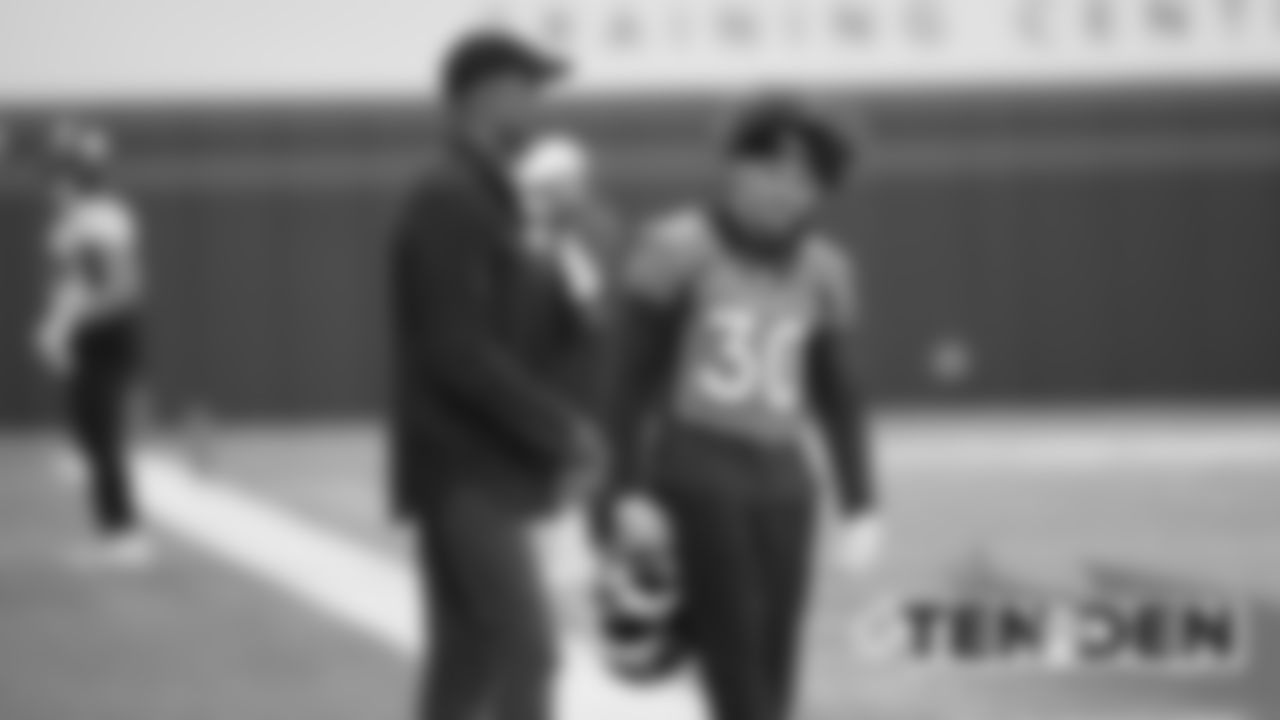Phillip Lindsay talks with James Lofton at practice on October 11, 2019 at UCHealth Training Center. (Photo by Ben Swanson)