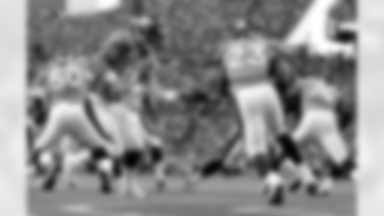 Running back Willis McGahee takes the handoff from Manning.