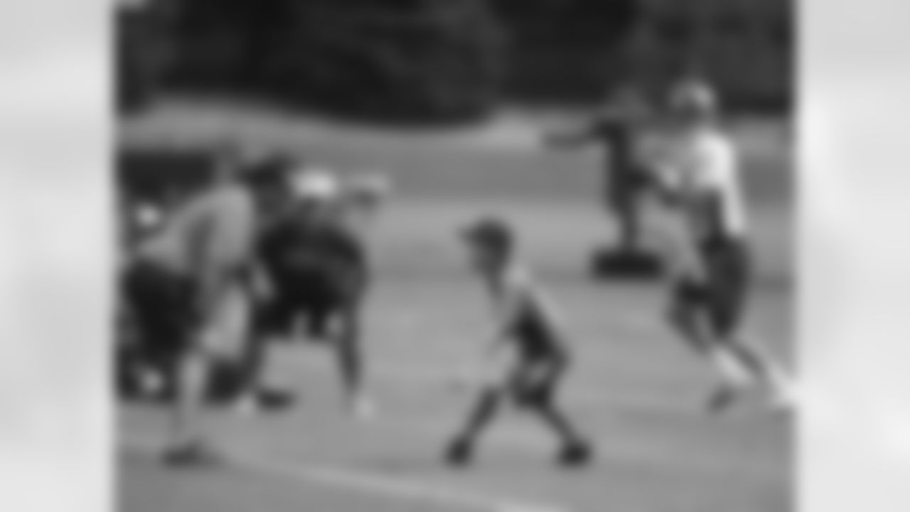 Denver Broncos quarterbacks coach Greg Knapp defends a young fan as Peyton Manning prepares to throw to him at training camp in 2015. Manning always made time for kids during training camp.