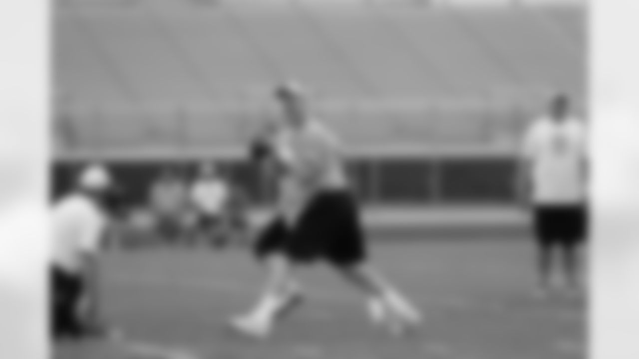 Manning drops back to pass.
