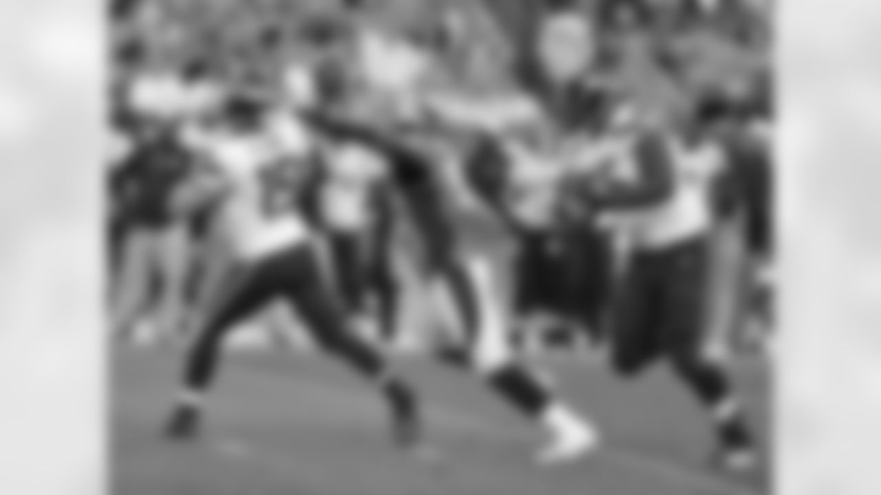 Dumervil, who drew a holding penalty, nearly sacks Flynn.