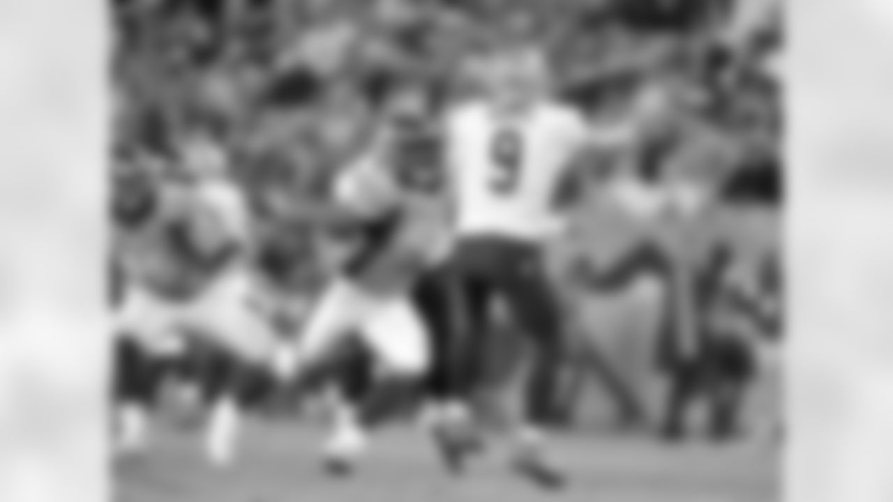 Pressure from LB Von Miller forces Saints QB Drew Brees to throw the ball away.