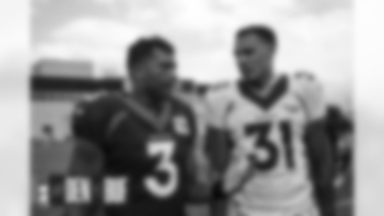 Russell Wilson talks with Justin Simmons at practice at UCHealth Training Center in Englewood, Colorado on August 15, 2022. (Photo by Ben Swanson)