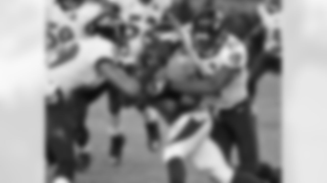 Hillman is wrapped up by Ravens defenders.