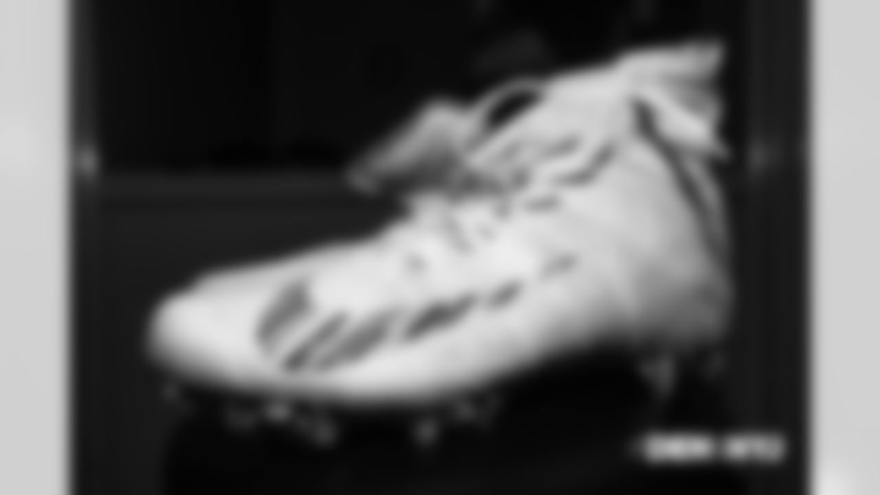 A pair of Crucial Catch Nike cleats in the locker room pregame before the Broncos' Week 5 game against the New York Jets at MetLife Stadium on October 7, 2018.