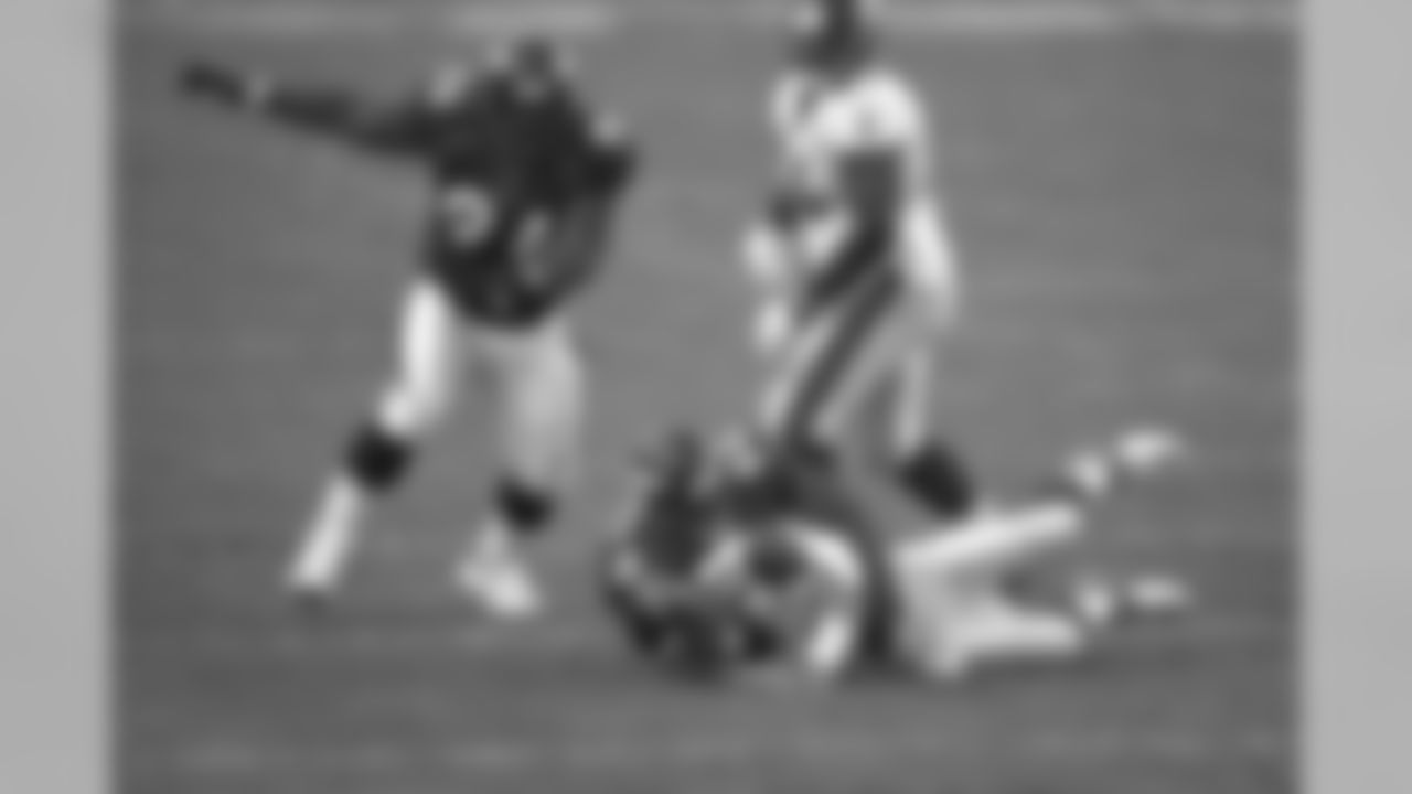 Harald Hasselbach wraps up the Falcons quarterback and forces a fumble at Mile High Stadium in Denver, CO on September 10, 2000.