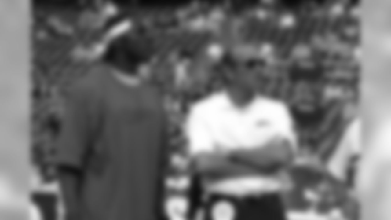Pat Bowlen chats with Shannon Sharpe during the pregame drills before a game against the San Diego Chargers at Qualcomm Stadium in San Diego, CA on December 1, 2002.