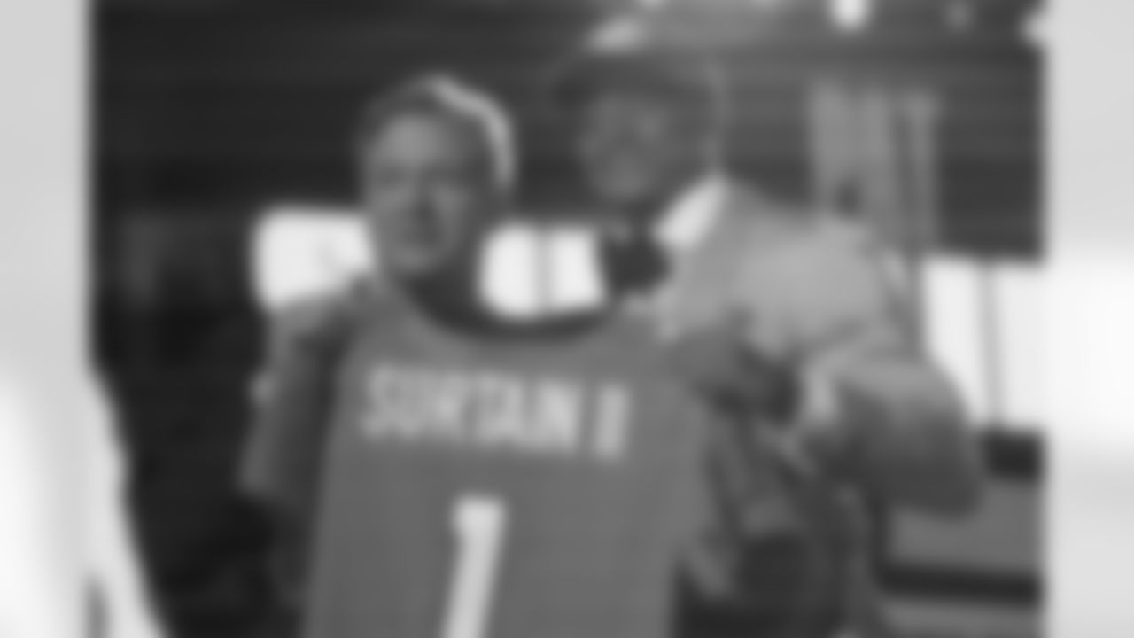 Alabama cornerback Patrick Surtain II, right, holds a team jersey with NFL Commissioner Roger Goodell after he was chosen by the Denver Broncos with the ninth pick in the NFL football draft, Thursday, April 29, 2021, in Cleveland. (AP Photo/Tony Dejak)