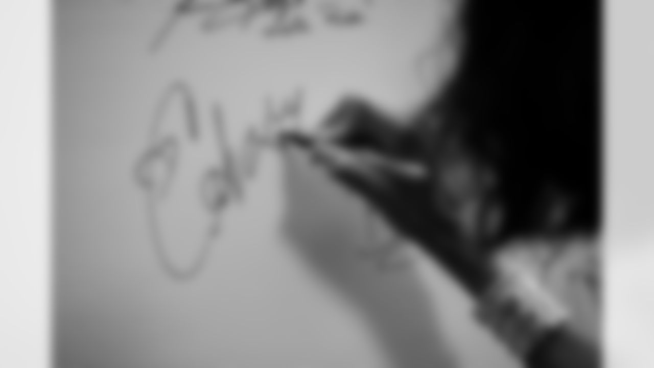 Ciara signs the Rockies' Wall of Fame during his visit to the Colorado Rockies' Opening Day game at Coors Field in Denver, Colorado on April 8, 2022. (Photo by Ben Swanson)