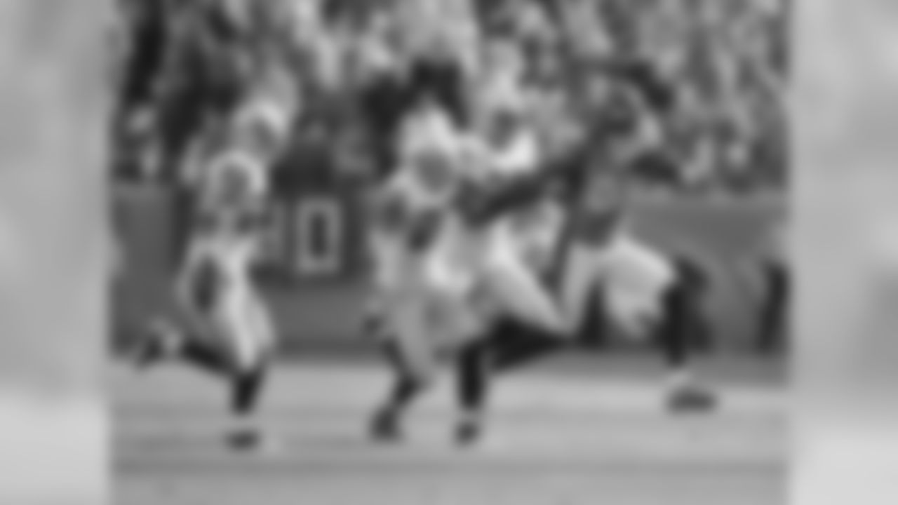 WR Demaryius Thomas stiff-arms a Raiders defender.