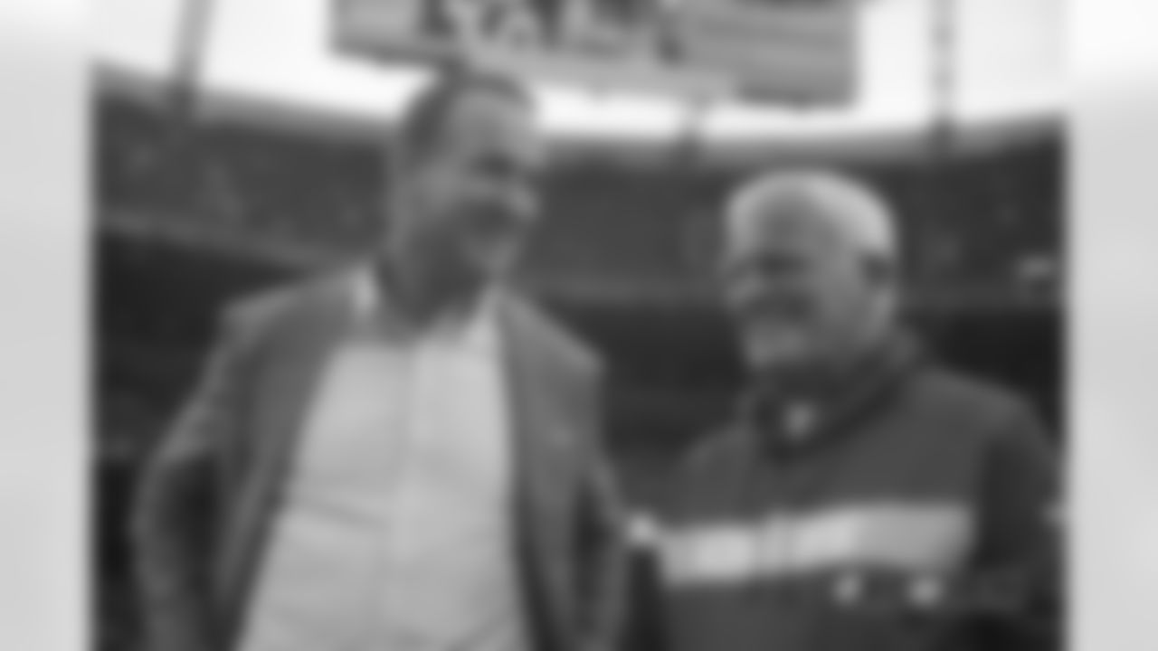 Peyton Manning talks with Chiefs defensive coordinator Bob Sutton during pregame warmups before the game against the Kansas City Chiefs at Broncos Stadium at Mile High on October 1, 2018.