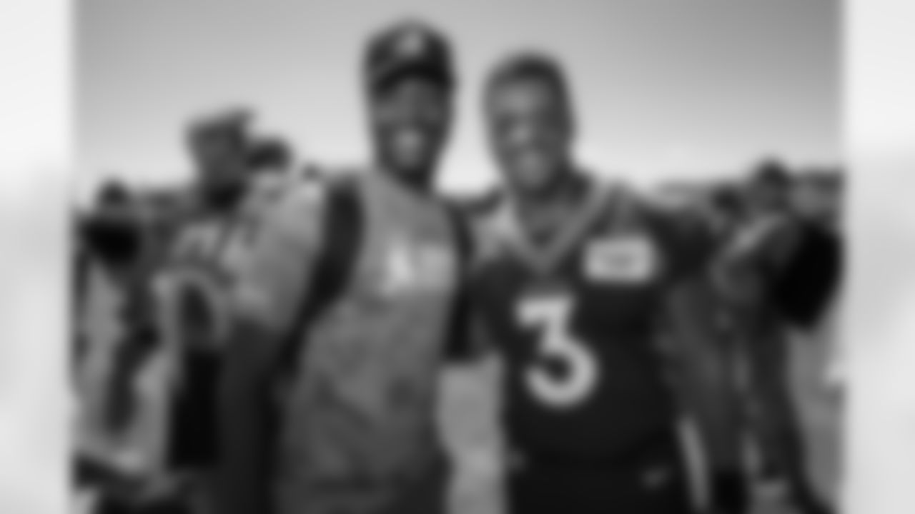 Russell Wilson poses for a photo with a military member during USAA's Salute to Service NFL Boot Camp at Centura Health Training Center on August 29, 2023 in Englewood, Colorado. Photo by Ben Swanson / Denver Broncos