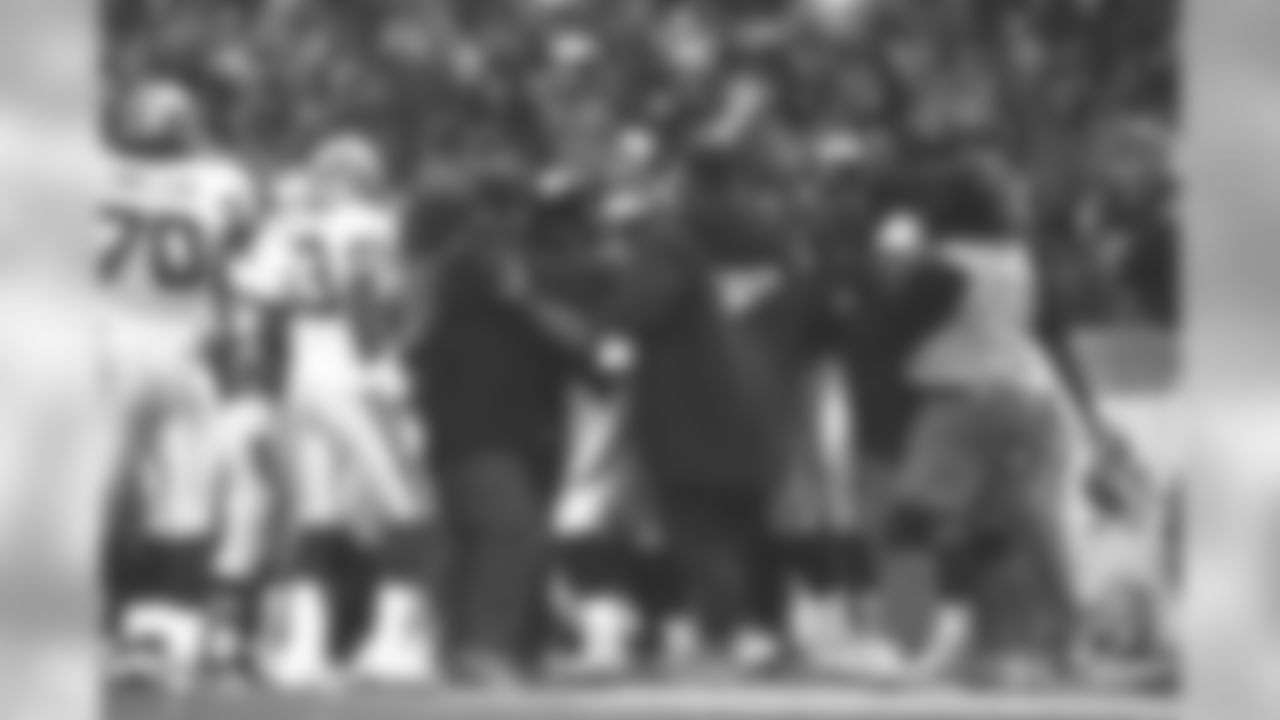 Terrell Davis is mobbed by teammates after putting himself over the 2,000-yard rushing mark for the season against the Seattle Seahawks at Mile High Stadium in Denver, CO on December 27, 1998.