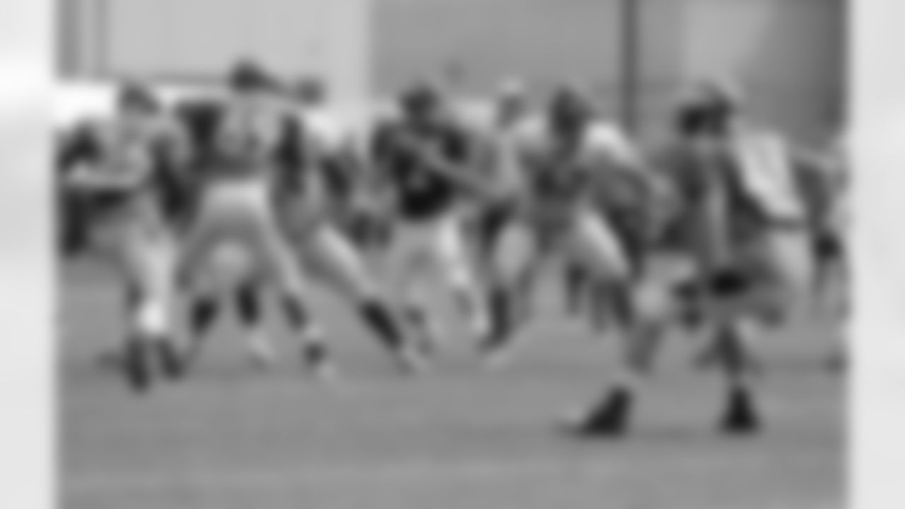 Dysert drops back to pass as Ben Garland points out an assignment.
