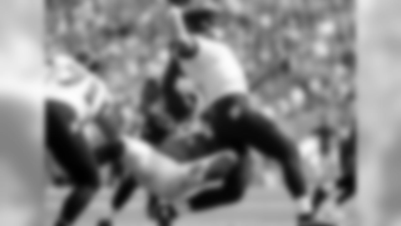 OLB DeMarcus Ware pulls QB Joe Flacco down from behind for a sack.