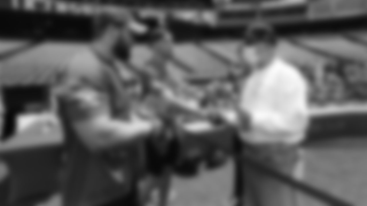 Justin Simmons and Andy Janovich greet a fan during UCHealth's Healthy Swings Charity Home Run Derby to benefit The Leukemia & Lymphoma Society- Rocky Mountain Chapter at Coors Field on June 11, 2019.