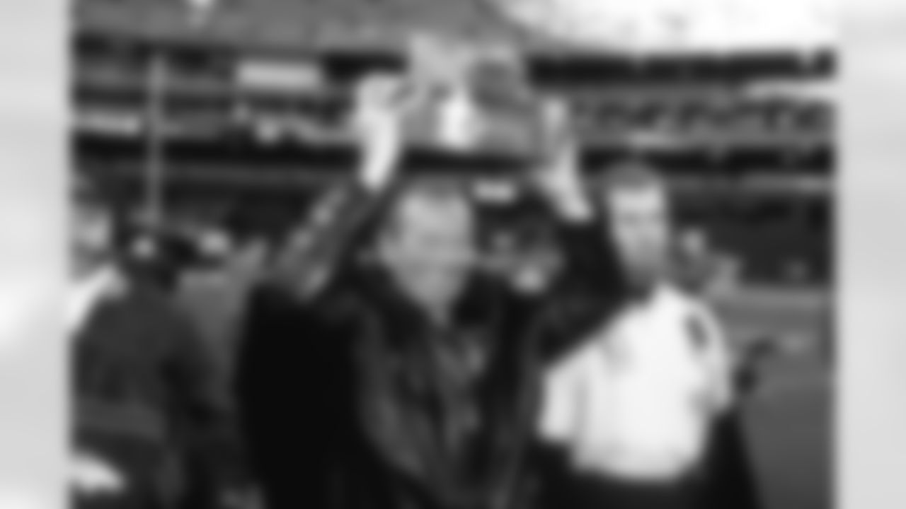Pittsburgh: Owner Pat Bowlen carries off the AFC Championship trophy after the win against the Pittsburgh Steelers at Three Rivers Stadium in Pittsburgh, PA on January 11, 1998.