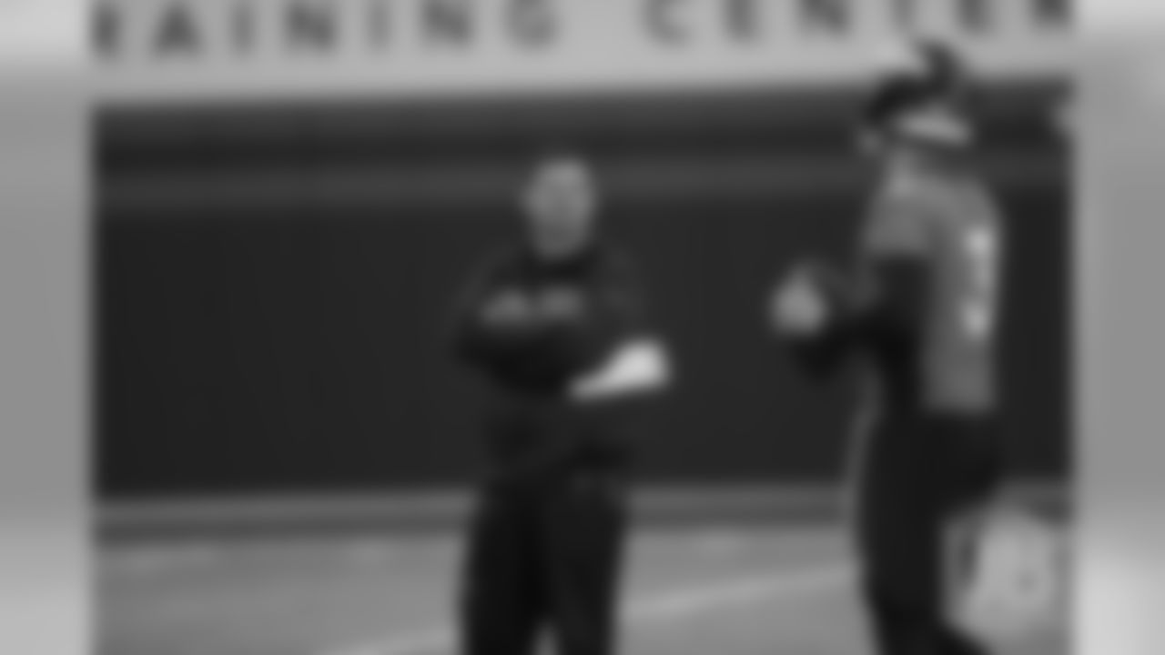 Offensive Coordinator Rich Scangarello talks with quarterback Drew Lock during the first day of rookie minicamp practice on May 10, 2019.