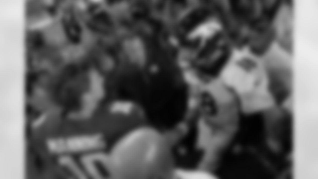 Brothers Eli and Peyton Manning share a moment after the game.